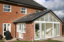 A brick and glass rear conservatory in Holmes Chapel by KJB Builders